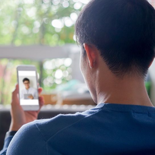 Young man video streaming conference to consulting about health with specialist