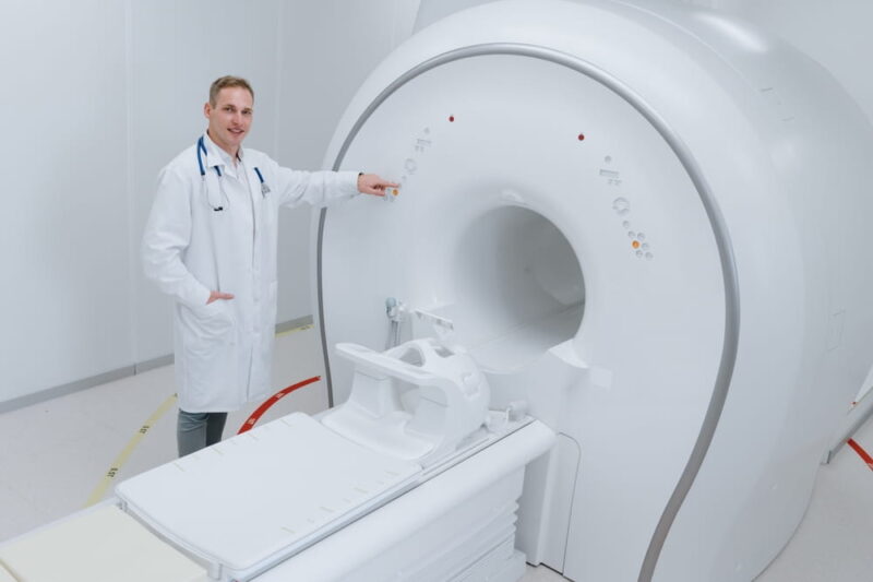 A doctor in the laboratory sets up a modern CT scanner for the beginning of the study