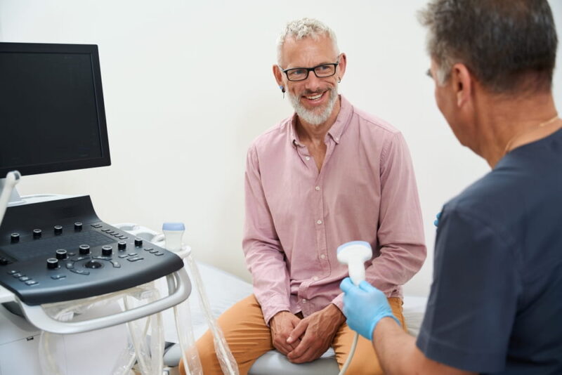 male patient receiving focused ultrasound therapy with doctor