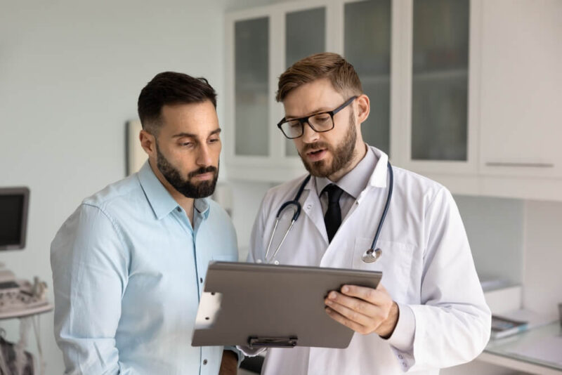 Male doctor with male patient