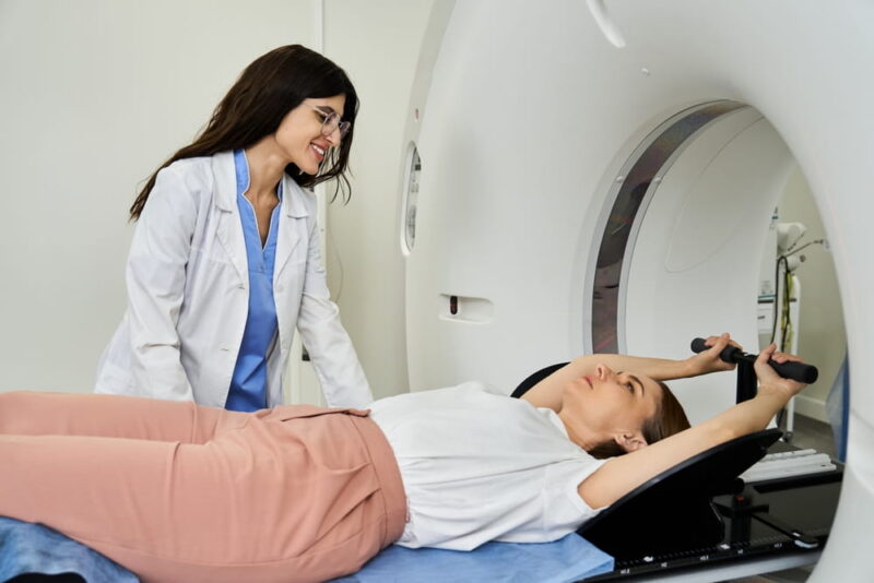 A dedicated doctor guides a patient into the MRI machine for an important diagnostic procedure.