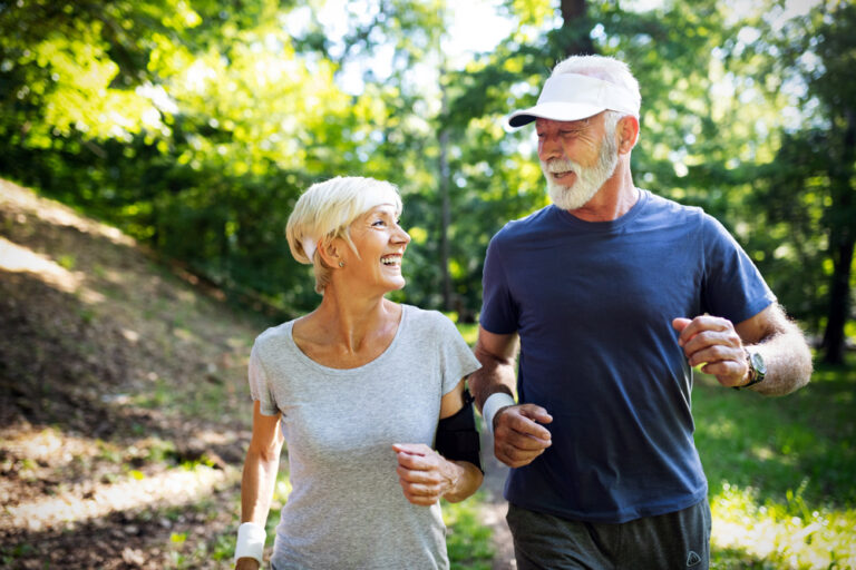 Fitness, sport, people, exercising and lifestyle concept - senior couple running