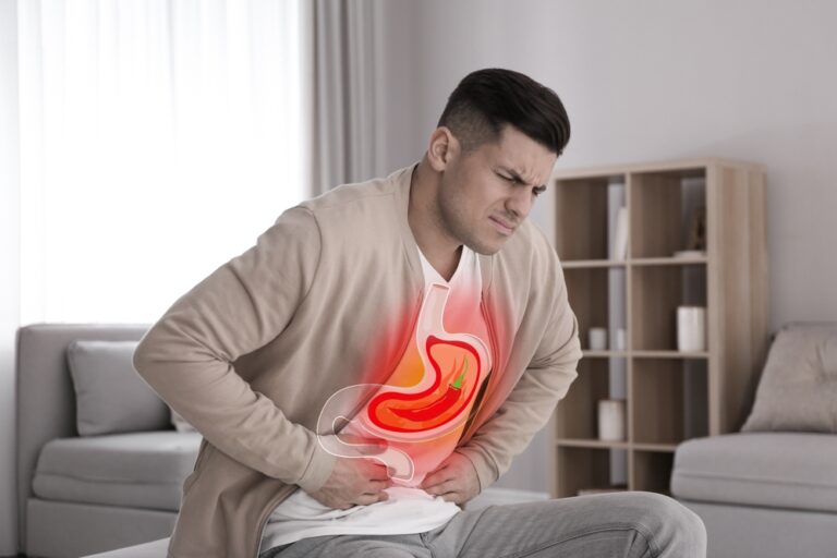 Man suffering from heartburn at home