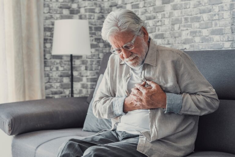 upset old middle aged grandfather touching chest feel sudden pain heartburn