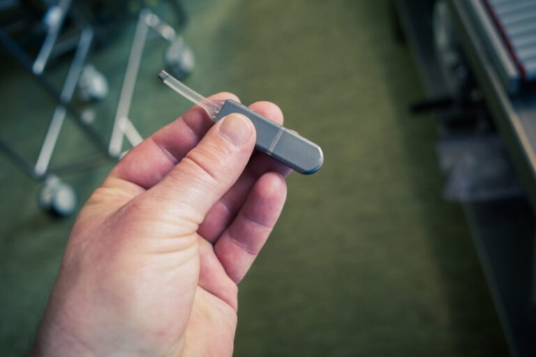 in one hand is an implantable event recorder to record heart problems