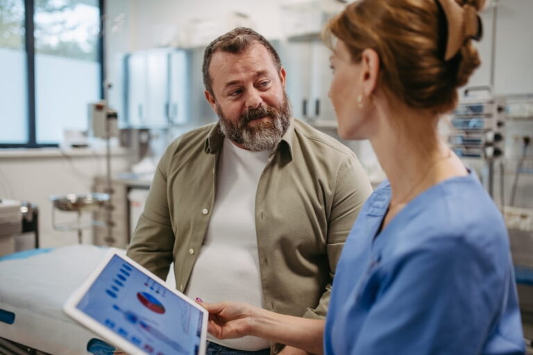 Female doctor consulting with overweight patient, discussing test result in doctor office
