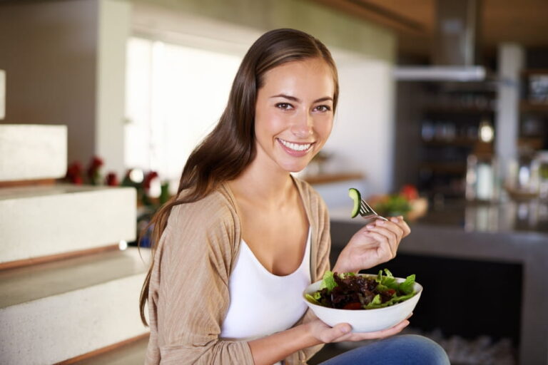 Salad, portrait and happy woman a house with breakfast, bowl or lettuce for balance, wellness or gut health at home
