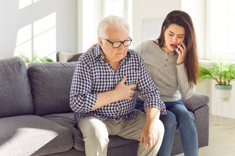 Senior man old father clutches chest in pain heart attack daughter calling to emergency.