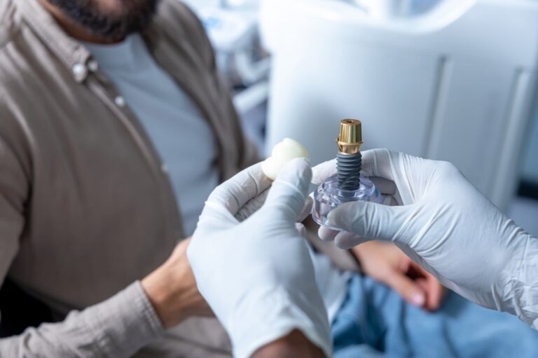 Male dentist in medical office e with patient during routine dental check