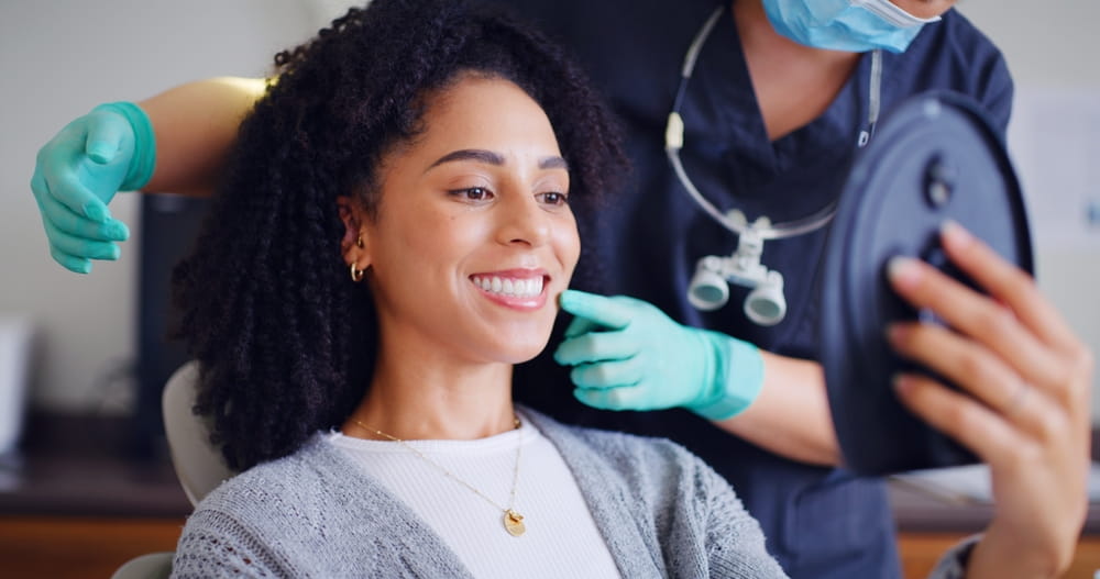Woman, smile and mirror for checkup with dentist, oral hygiene and mouth cleaning service.