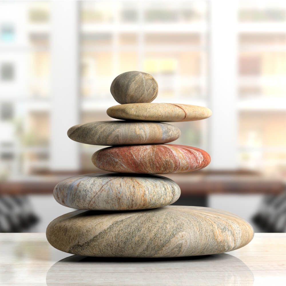 Relaxation at the office. Zen stones stack on an office desk