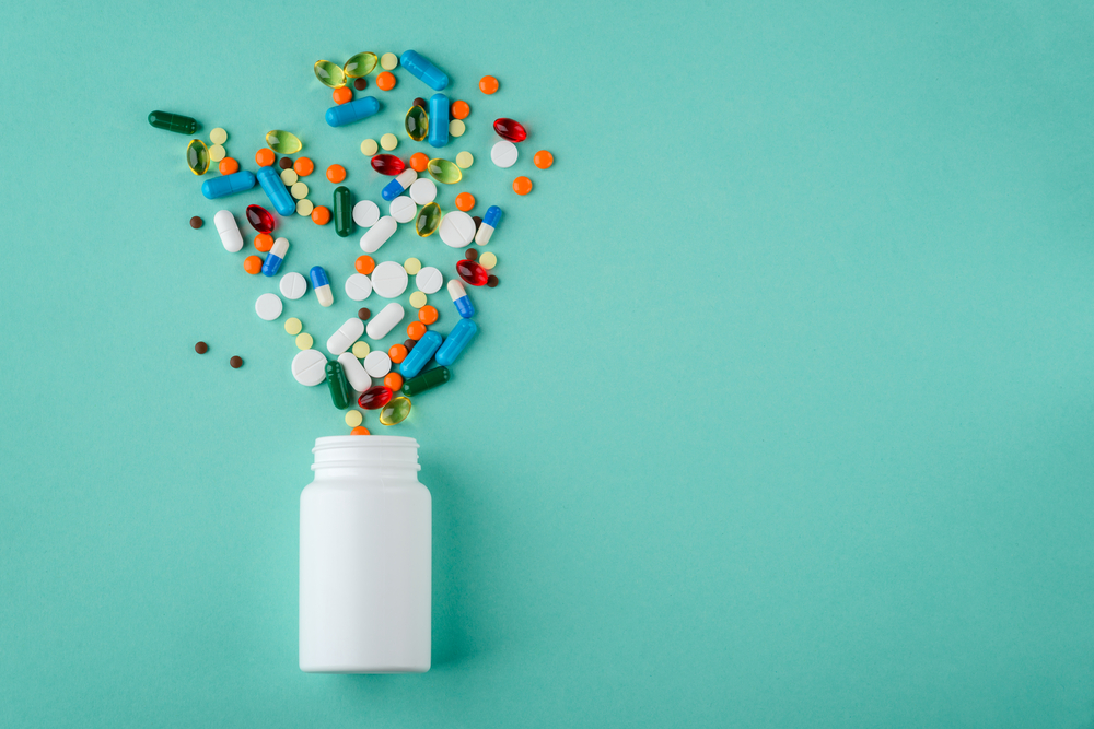 Various,Medications,And,Vitamins,,A,Pill,Bottle.,Pastel,Background,,Place