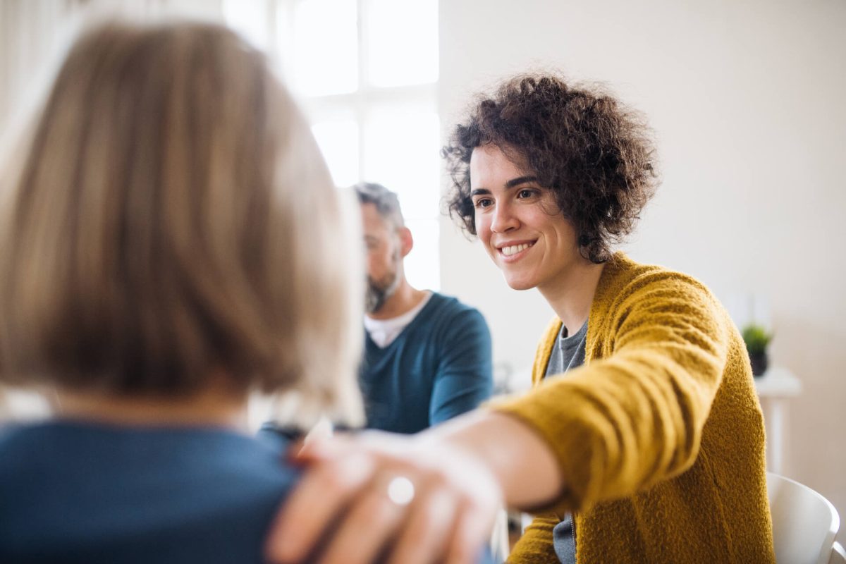 Men and women sitting in a circle during group therapy