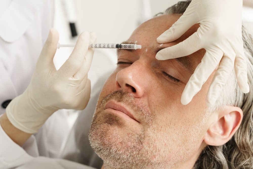 Middle aged male client getting injections medspa