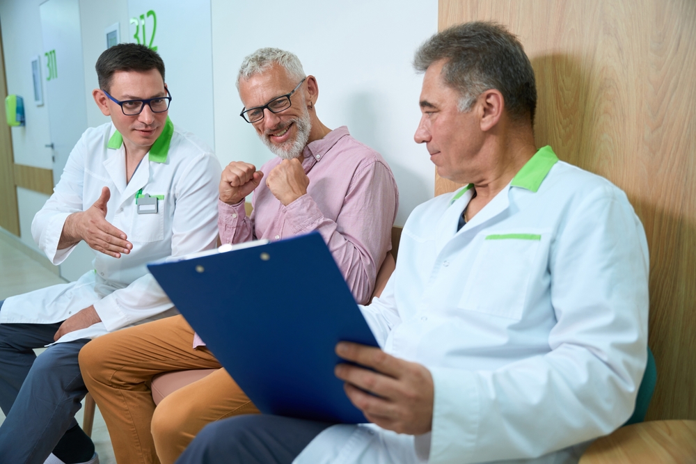 Joyful man communicates with employees of a medical center