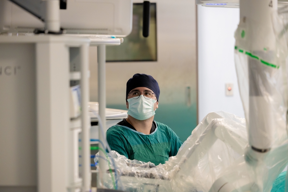 A Surgeon is assisting robotic prostatectomy surgery.