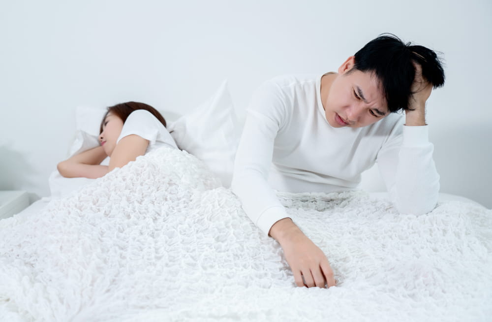 Asian men are sitting stressed about having sex with their wife. Which is caused by inefficiency Sexual And stress