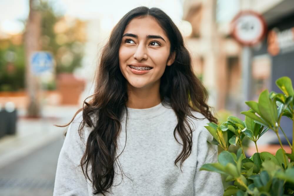 Young woman smiling while walking at the city