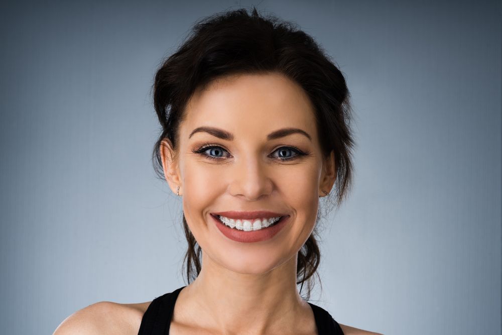 Woman smiling with Clear Ceramic Braces