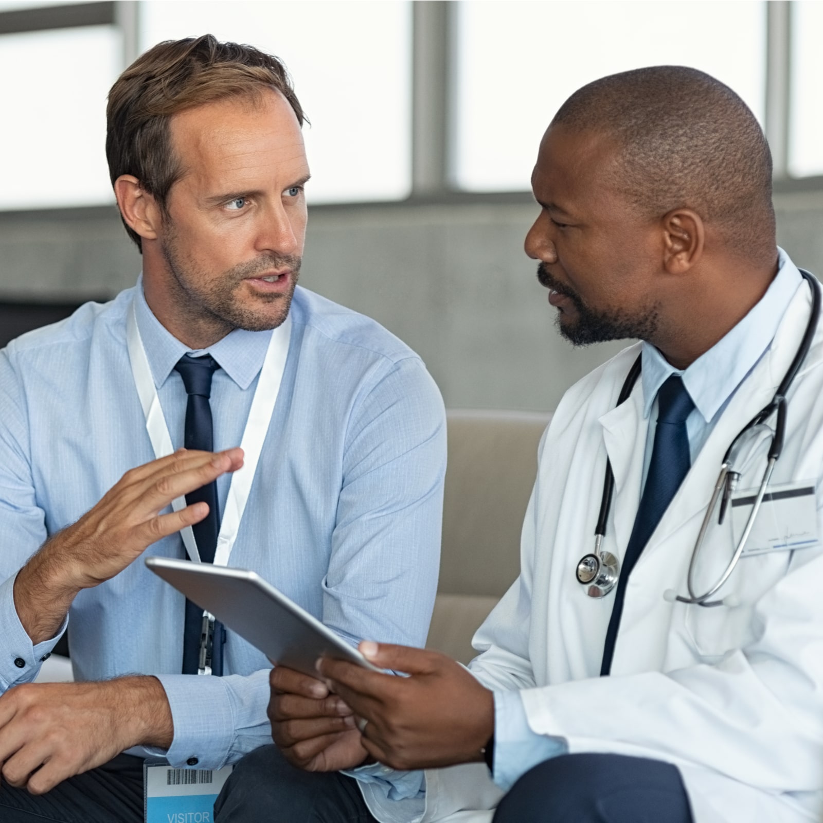 Pharmaceutical representative talking with doctor.