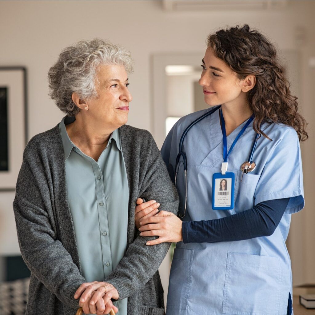 Young caregiver helping senior woman walking