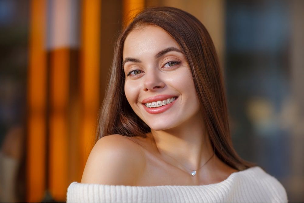 beautiful happy smiling young woman with braces