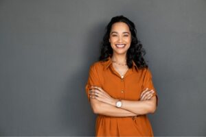 young latin woman with pleasant smile and crossed arms