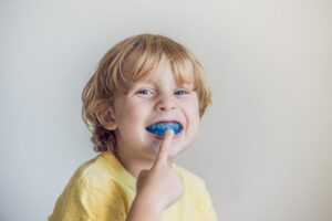 Three-year old boy shows myofunctional trainer to illuminate mouth breathing habit