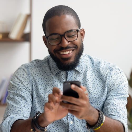 Happy african american businessman using phone mobile