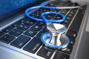 stethoscope on laptop keyboard