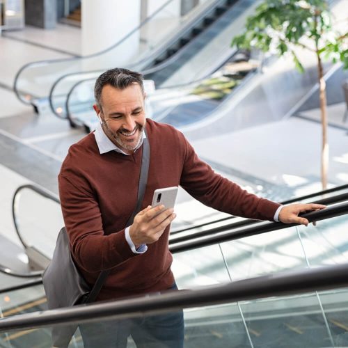 Mid adult business man smiling while reading message