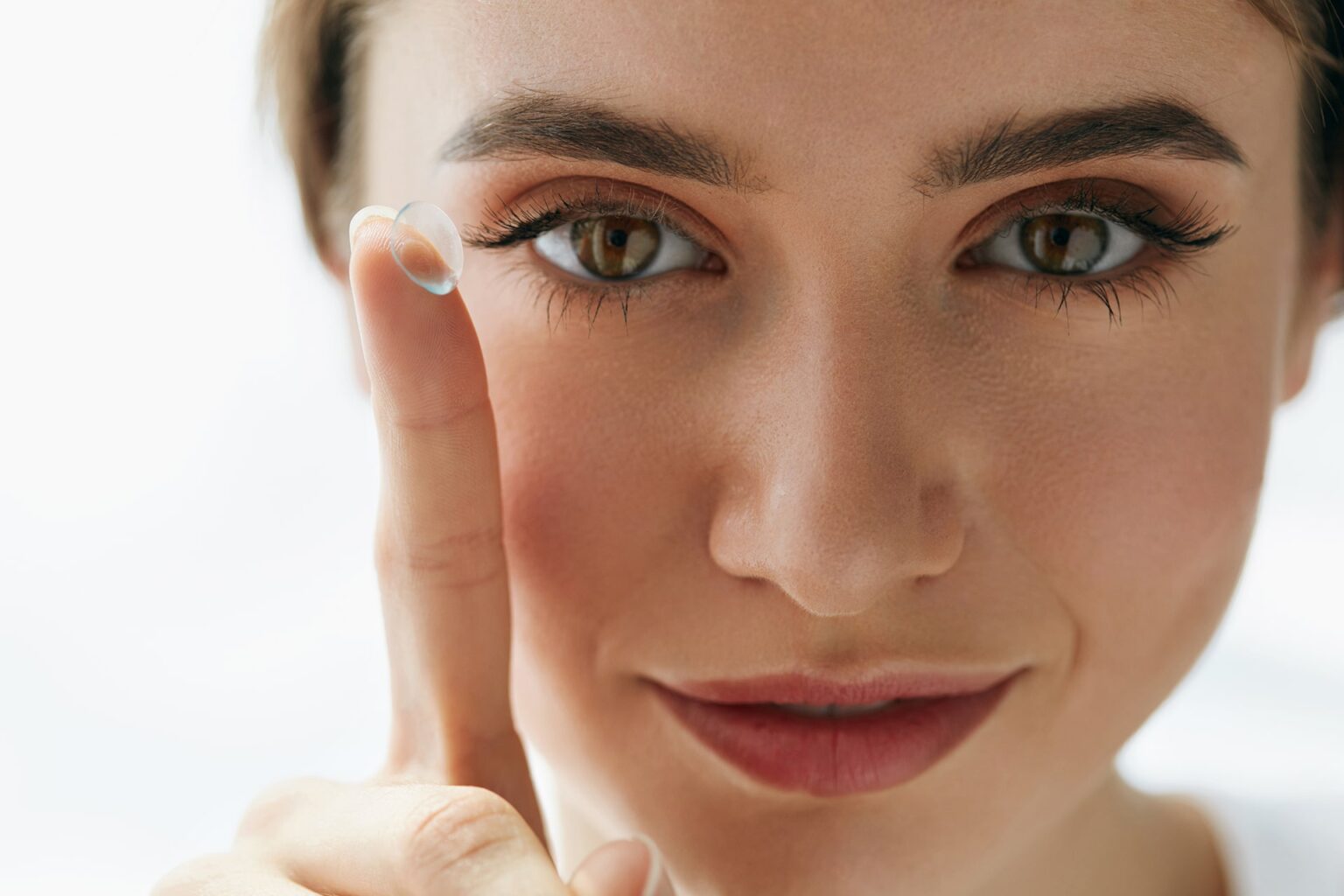 Woman Holding Contact Lens on Finger