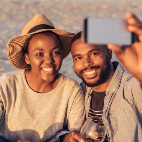 Smiling young African couple sitting together