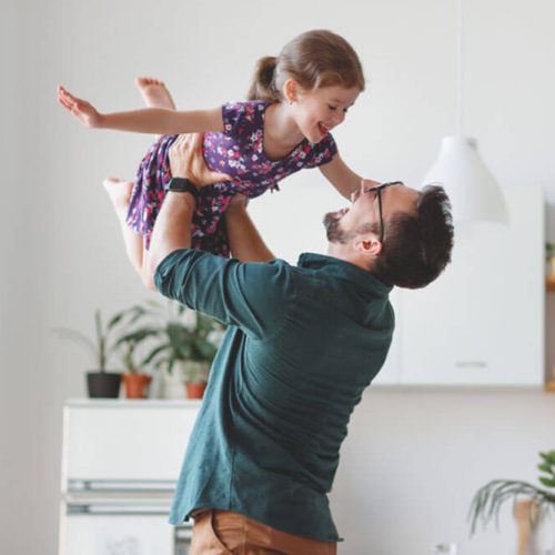 Father's day. Happy family daughter hugs his dad on holiday