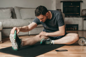 Man doing stretching exercises on a mat