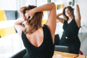 Beautiful smiling young woman plus size body positive in black evening dress