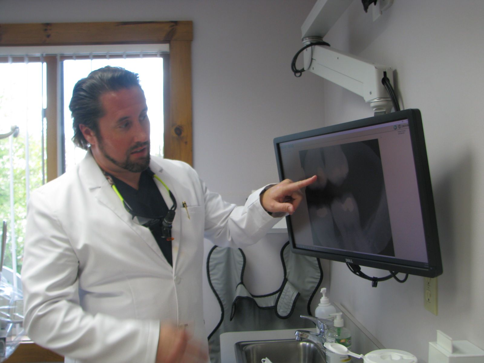 Dr. Nicholas Ciancarelli pointing toward screen