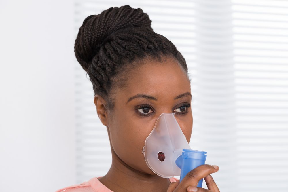 Young Woman Using Oxygen Mask