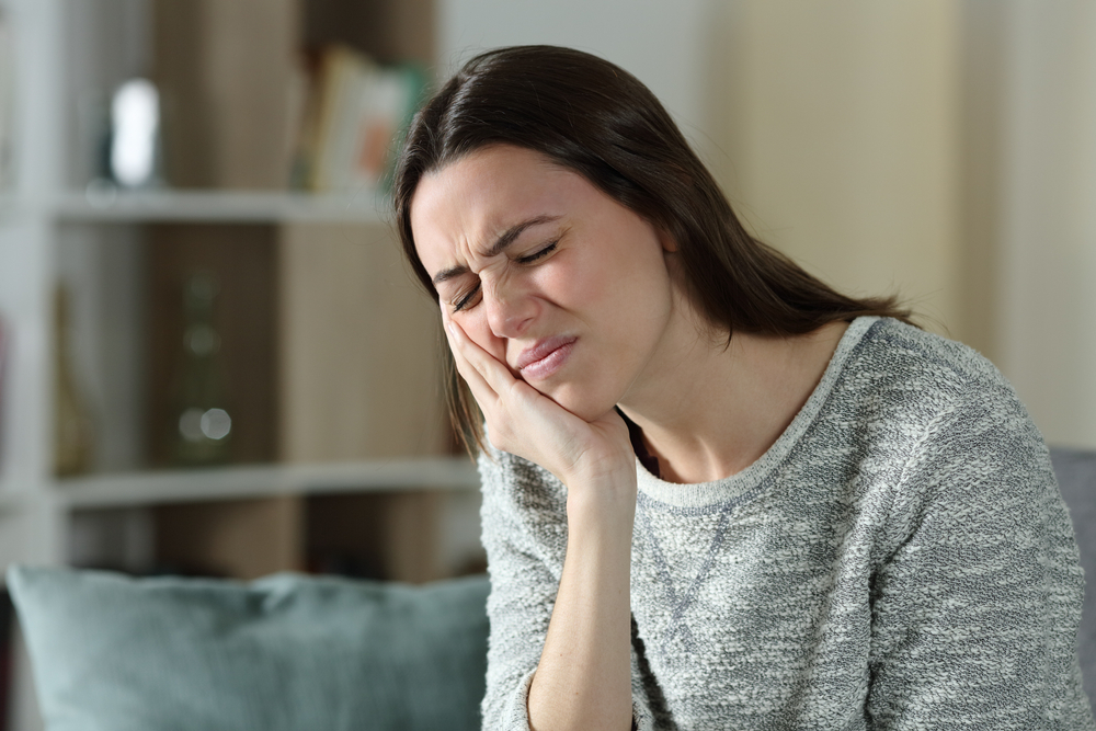 Stressed Woman Complaining Suffering Toothache Sitting On A Couch At