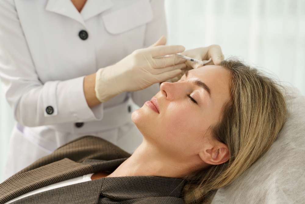 Female Client During Facial Filler Injections In Aesthetic Medical Clinic