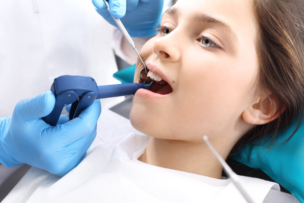 Treatment of tooth loss, the child to the dentist. Child in the dental chair dental treatment during surgery.