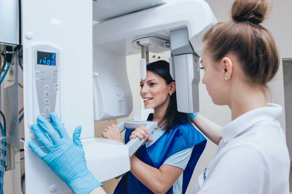 Young woman patient standing in x-ray machine