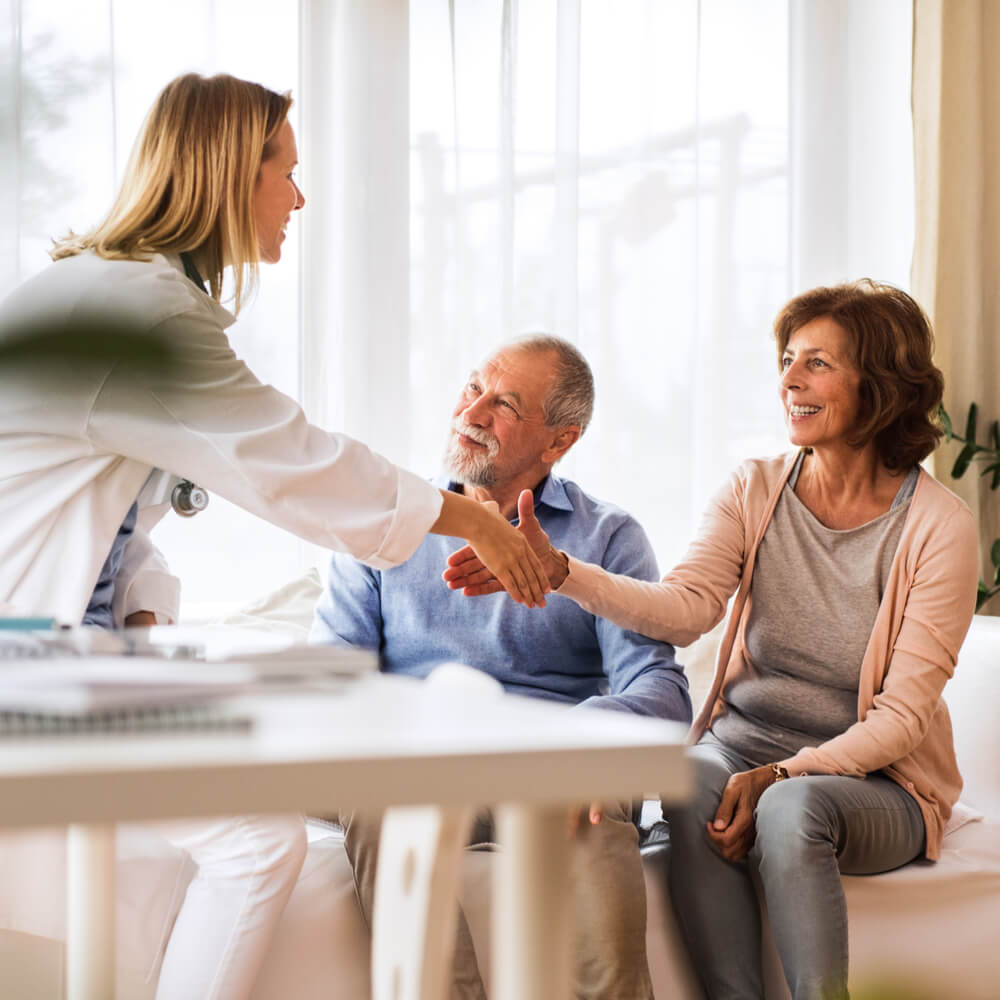 Female doctor talking to a senior couple.