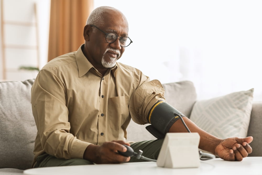 Hypertension In Older Age. Senior Black Man Measuring Arterial Blood Pressure Having Problems With Tension