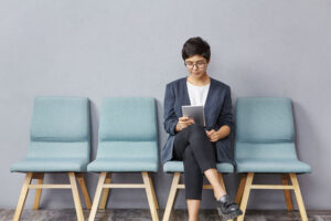 Confident successful young businesswoman with short hairstyle wearing stylish clothes and glasses