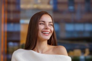 Emotional portrait of a beautiful happy smiling young woman with braces