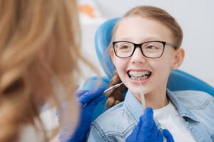 Positive smiley ginger having her braces checked