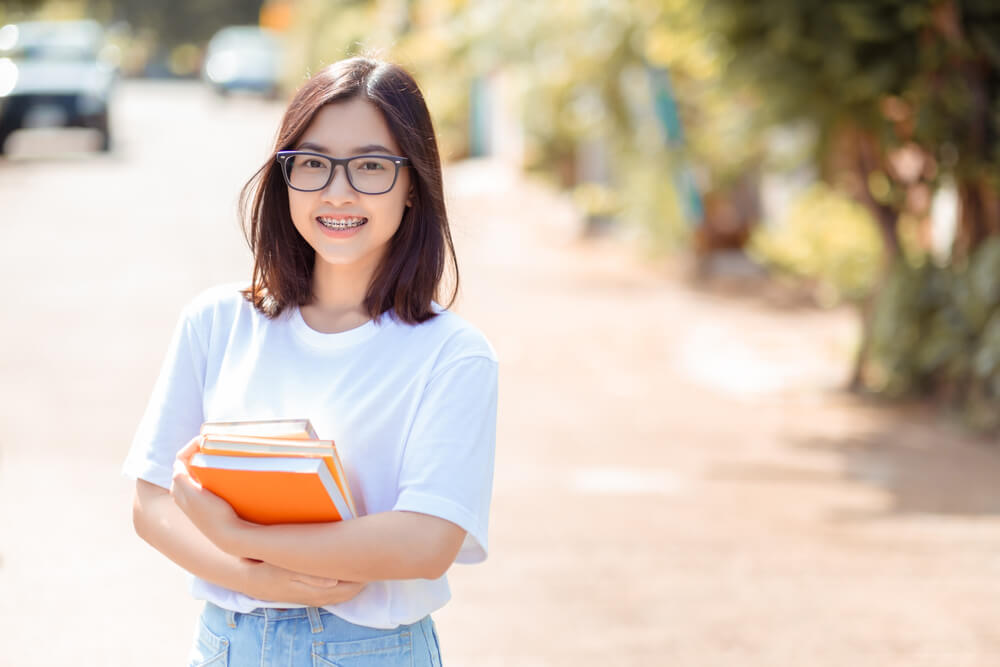 Portrait of young student asian woman wearing braces beauty smil