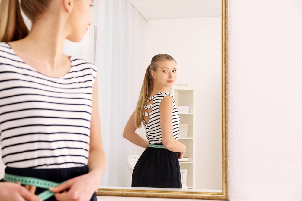 Blonde Woman Looking in Mirror