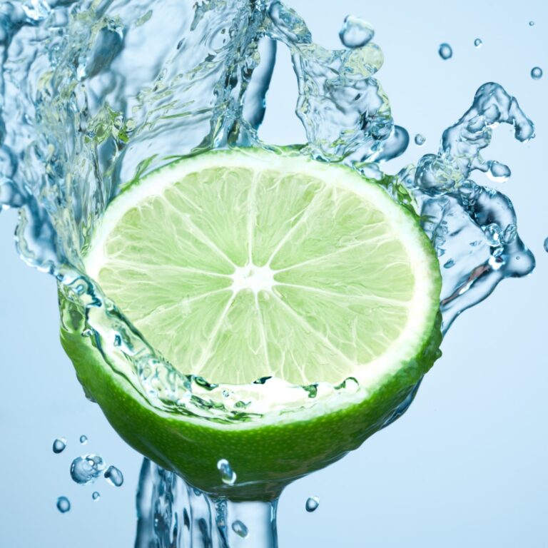 lime in spray of water. lime cucumber with splash on background